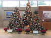 Three of twelve trees decorated for Christmas in the Ford Orientation Center